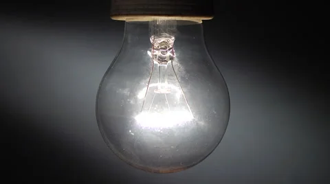 Close up of a real tungsten lamp turning on and off on a window light background Stock Footage 47643750