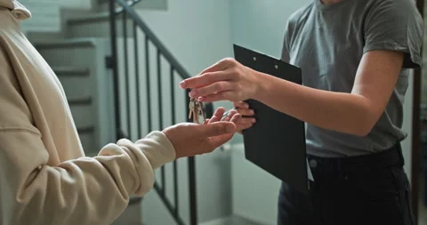 Close up a realtor girl using a tablet in her hands gives a bunch of keys to a Stock Footage 280645097