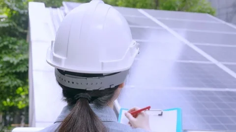 Close up, rear angle of unrecognizable Asian engineer working outdoors, writing Stock Footage 156688878