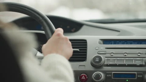 Close up rear view of lady driving car with dashboard controls and blur outside Stock Footage 310177151