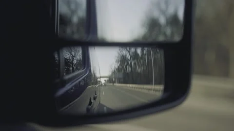 Close-up, rear-view mirrors while the minibus is moving along the road Stock Footage 195219789