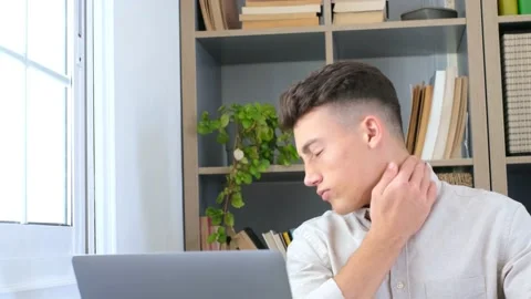 Close up rear view stressed young man touching lower neck feeling discomfort, su Stock Footage 155345041