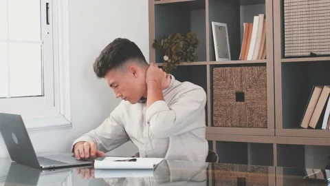 Close up rear view stressed young man touching lower neck feeling discomfort, su Stock Footage 155345180