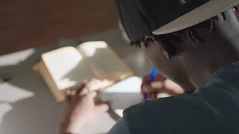 Close Rear View Student Writing Notes in Library Stock Footage 318703186