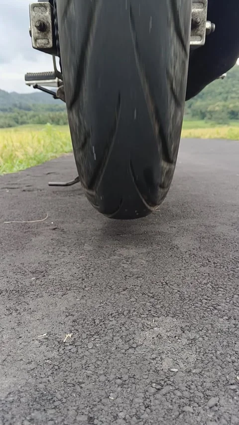 Close up of the rear wheel of a motorcycle spinning Stock-Footage 336933529