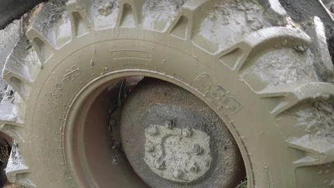 Close up of the rear wheel of a tractor in the field Stock Footage 314574175