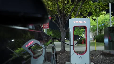 Close up of recharging process of Tesla electro mobile. Side mirror is closing Stock Footage 318049926