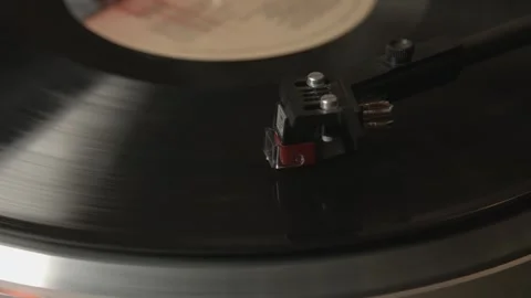 Close up of record player needle on spinning vinyl record playing music, of.. Stock Footage 337384700