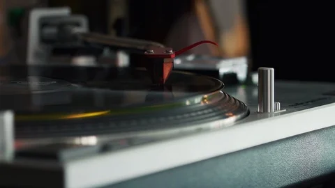 Close up of a record playing on a turntable with a chrome arm and red cartridge Stock Footage 127323062