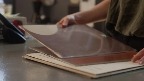Close-up of a record store clerk chats with a customer behind the counter 스톡 동영상 122587103