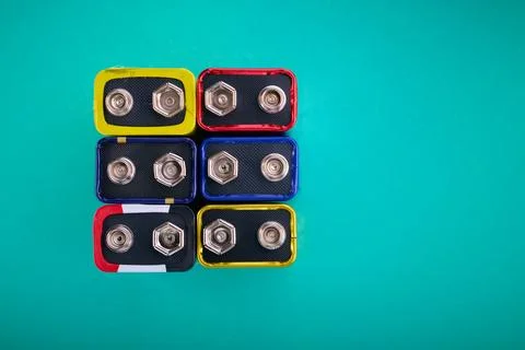 Close-up of a rectangular 9 volts batteries on a green table. Stock Photos