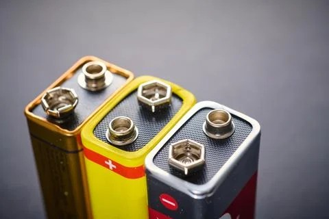 Close-up of a rectangular 9 volts batteries on a black table. Photos