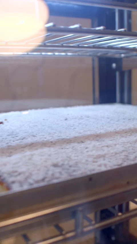 Close-up of rectangular sponge cake in metal pan on oven rack Stock Footage 336534616