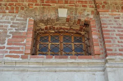 Close-up of a rectangular window behind a metal figured lattice. Stock Photos