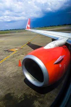 Close-up of Red Airplane Jet Engine and Wing on Airport Runway Stock Photos
