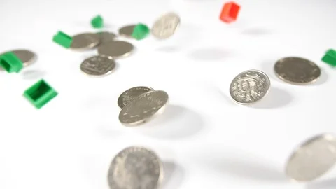 Close up of red and green game house playing board game pieces and silver coin Stock Footage 89189757