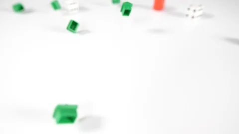 Close up of red and green game house playing board game pieces with scattered Stock Footage 89190117
