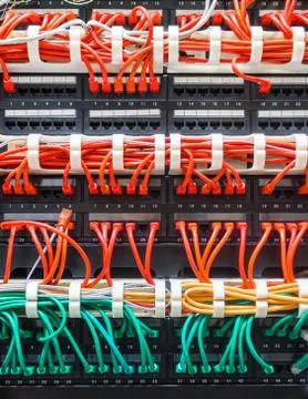 Close up of red and green network cables connected to switch Stock Photos