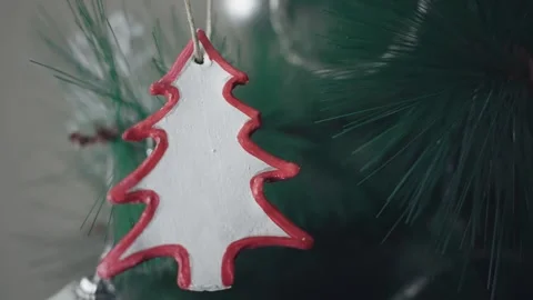 Close up of red and white pine tree bauble hanging on a festive traditional C Stock Footage 251988703