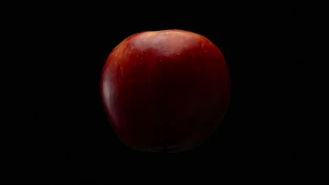 Close-up, red apple on a black background in rotational motion Stock Footage 172474719