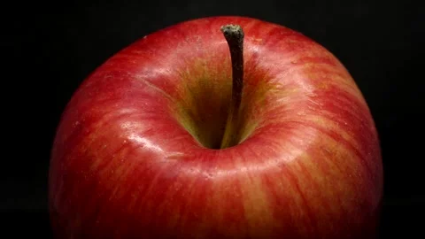 Close-up red apple on a black background Stock Footage 190011604