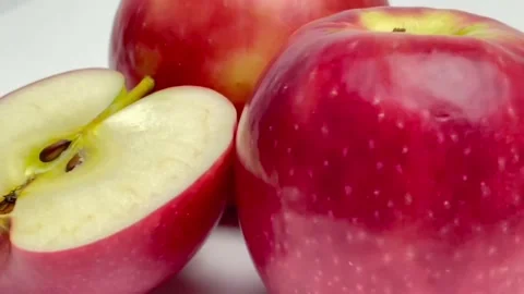Close up red apple is rolling isolated on white background Stock Footage 158033807