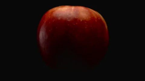 Close-up, red apple in turning motion on a black background Stock Footage 176463544