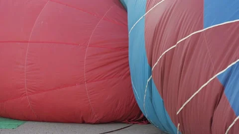 Close-up red balloon is prepared for take-off, inflated with large powerful fan Stock Footage 144247085