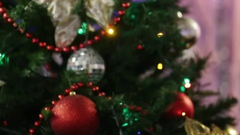 Close-up of red balloons hanging among the green branches of a Christmas tree Stock Footage 227205765