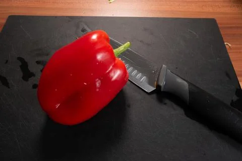 Close Up of Red Bell Pepper with Kitchen Knife Stock Photos