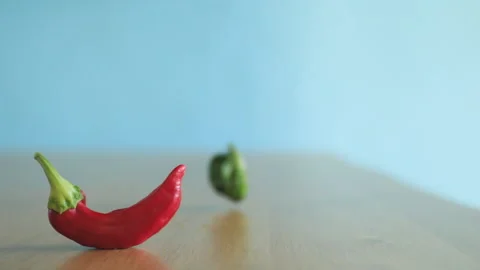 Close up red bell pepper, more peppers fall out of focus, in slow motion Stock Footage 167269532