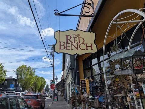 Close-up of The Red Bench sign surrounded by eclectic antiques Photos