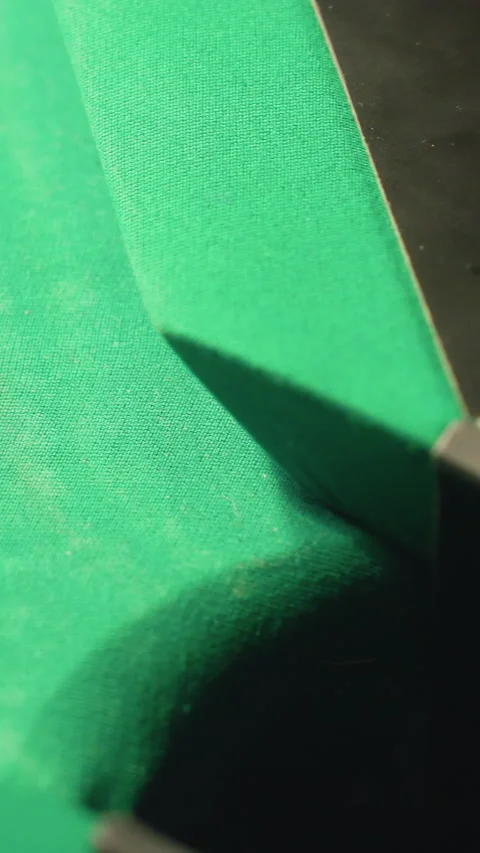 Close-Up of Red Billiard Ball Rolling into Pool Table Pocket on Green Surface 動画素材 319801024