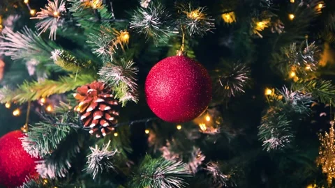 Close up of Red bobble on xmas tree at home in living room. flashing lights of 2 Stock Footage 143676146