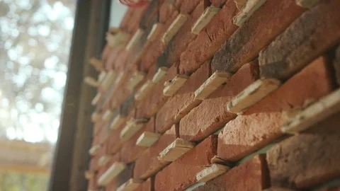 Close-up of red brick construction sunlight block brick bricklayer building Stock Footage 95928492