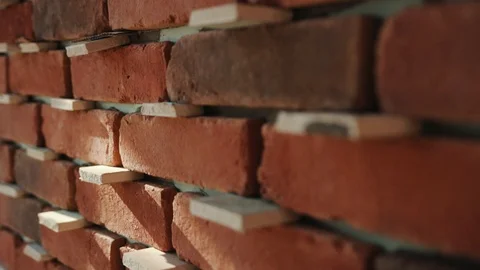 Close up of red brick construction sunlight block brick bricklayer building Stock Footage 95928668