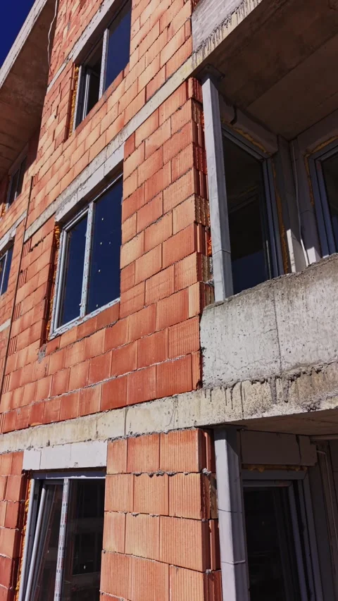 Close up of red brick wall and windows of a new building Video stock 338187567