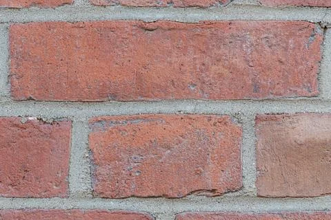 Close-up of red brick wall with gray mortar detail 写真素材
