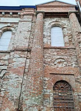 Close up of a red brick wall with round column and arched windows showing b.. Stock Photos