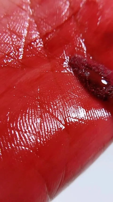 Close up of red brush rubbing lip skin. Red lipstick liquid being applied t.. Video stock 346879775