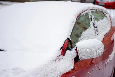 Close-up of a red car element covered in snow and ice Stock Photos
