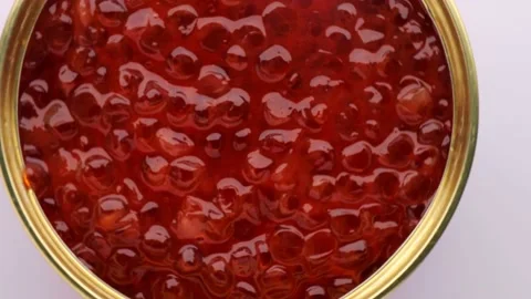 Close up of red caviar , rotation shot. red caviar canned in a round iron jar Stock Footage 232898320