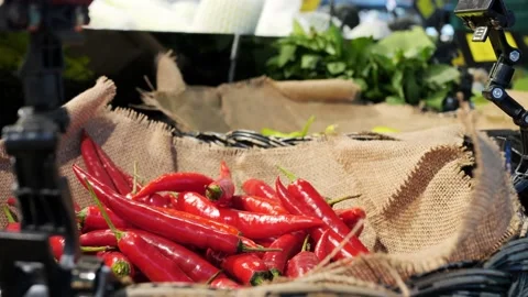 Close-up of red chili pepper in vegetable vendors basket at eco farmers market Stock Footage 227533369