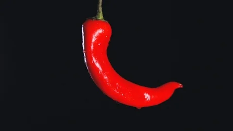 Close-up of red chilli pepper that rotates in a circle in slow motion. Stock Footage 112647936