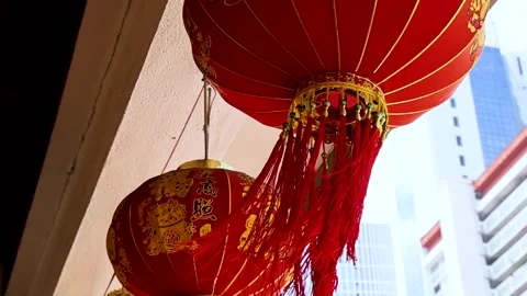 Close Up of Red Chinese Lanterns Swaying Against Urban Skyscrapers Stock Footage 326876357