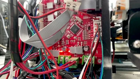 Close up of red circuit board with chips transistors, white markings and Video stock 166437594