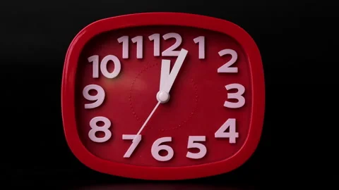 Close-up of red clock time lapse on black background. The hands of the red wall Stock Footage 261257517