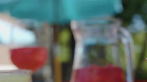 Close Up of Red Cocktail Being Poured into Glass Outdoors Vidéo 325689724