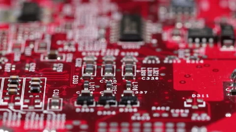 Close up of red computer circuit board with transistors and white markings Stock Footage 141345620
