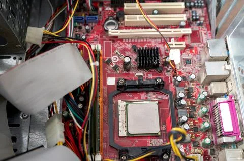 Close-up of red computer motherboard with cpu and wires visible Stock Photos